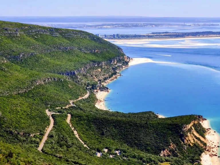 Green ridge of Serra da Arrabida to Portinho da Arrábida with view to Setúbal porto meeting white beaches and paradisiac blue sea