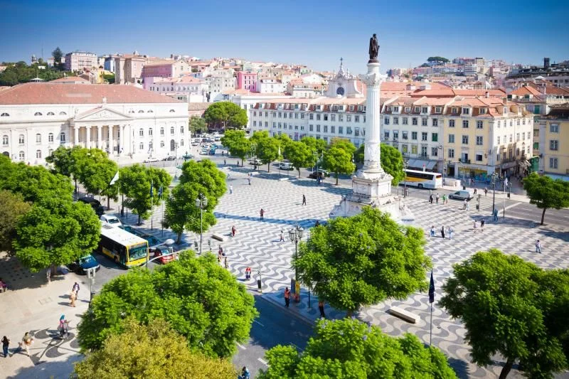 Aerial view of Rossio Square in Lisbon, with its wave-patterned pavement, central column and surrounding historic buildings