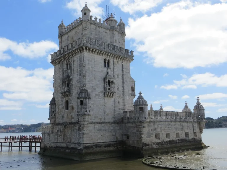 Belem Tower on the Tagus riverfront in Lisbon under a blue sky
